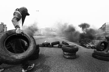Piqueteros in Argentina establishing a fire tire blockade, 2000.