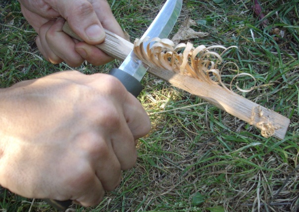Making a feather stick for fire starting.